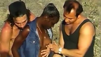 Two White Guys Pleasure A Black Woman On The Seaside In A Threesome