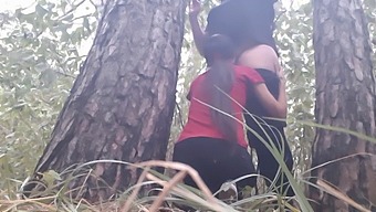 Lesbian Couple Gets Intimate Under A Tree During A Rainstorm